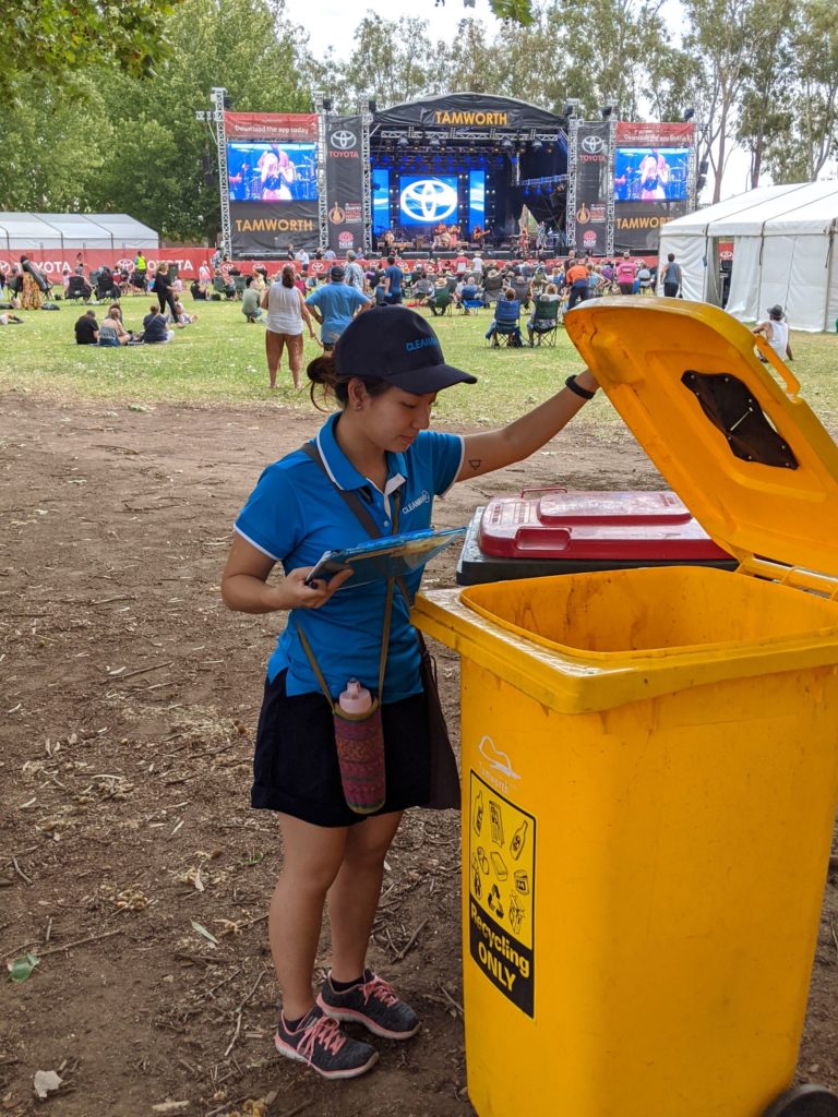 Resource Recovery Officer Evelyn doing a visual audit of a recycling bin to check for contamination